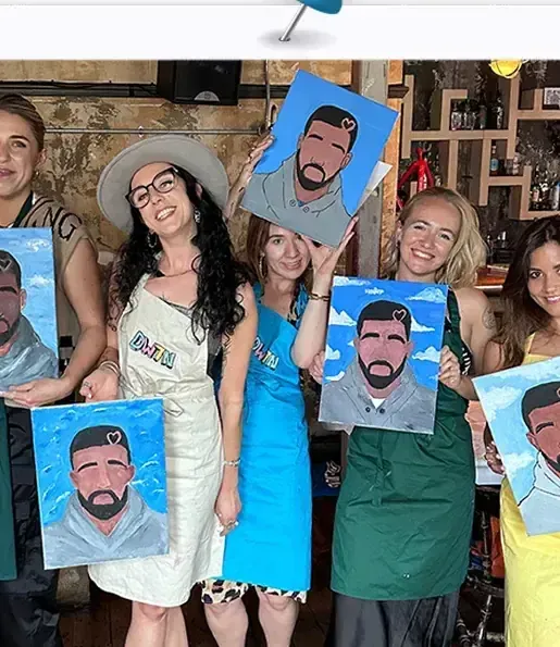 Guest holding a hand-painted portrait of Drake (Champagne Papi) at DWTN
